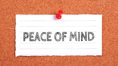 A piece of lined paper pinned to a corkboard with the words "PEACE OF MIND" written in bold, sketch-style letters.