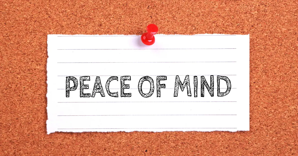 A piece of lined paper pinned to a corkboard with the words "PEACE OF MIND" written in bold, sketch-style letters.