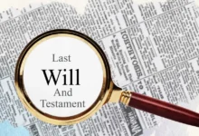 A magnifying glass highlighting the words "Last Will And Testament" on a newspaper background.