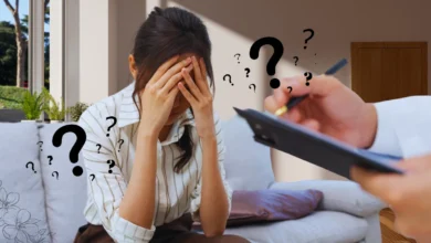 Worried woman in therapy, surrounded by question marks symbolizing anxiety.