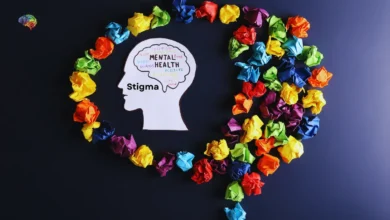 Mental health stigma concept with colorful paper and head silhouette.