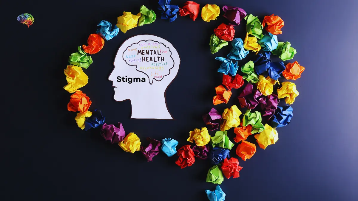 Mental health stigma concept with colorful paper and head silhouette.