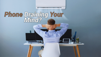 Man overwhelmed at desk with text "Phone Draining Your Mind