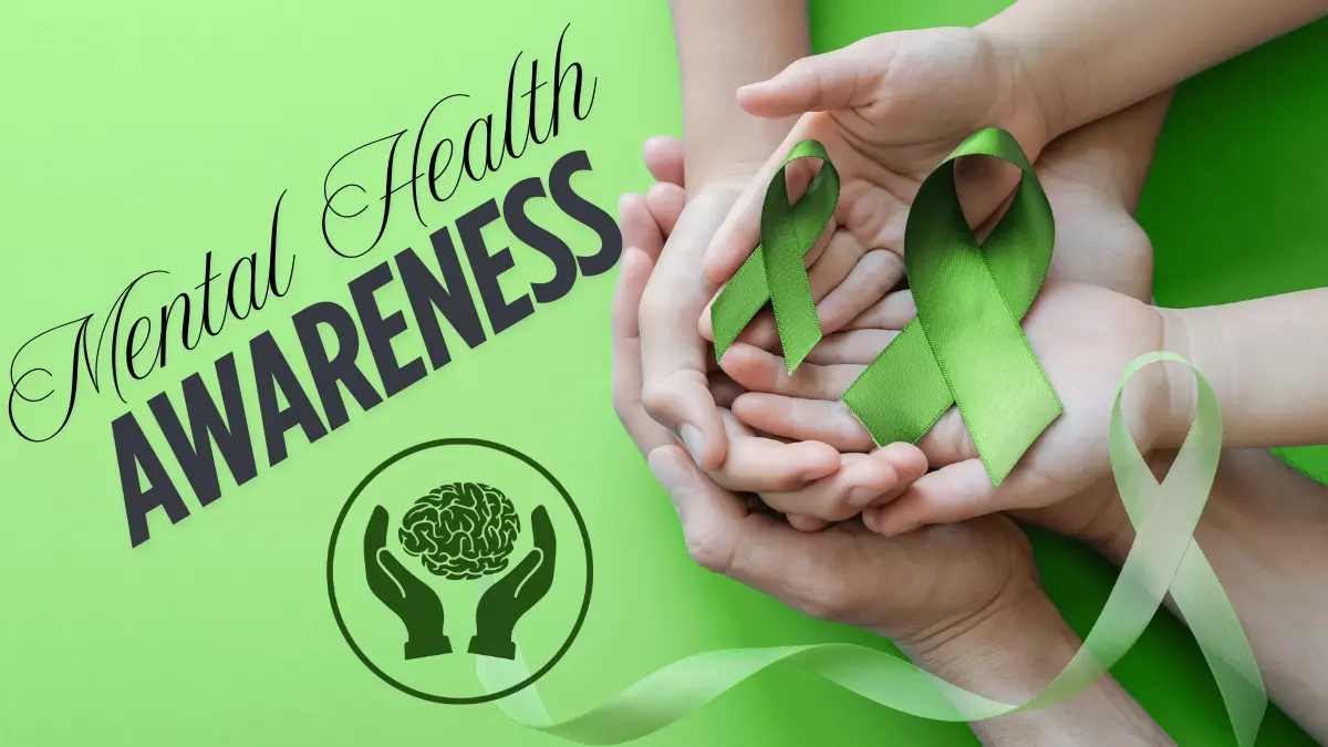 Hands holding green ribbons for mental health awareness and support.