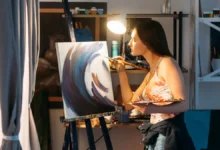 Woman painting on canvas during art therapy session for mental health improvement