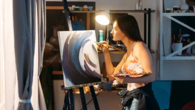 Woman painting on canvas during art therapy session for mental health improvement