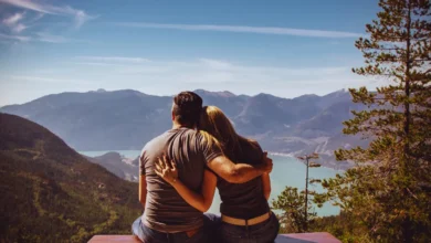 Couple sitting peacefully on a mountain, symbolizing emotional healing and mental peace.