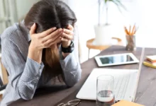 Tired woman with mental fatigue at work