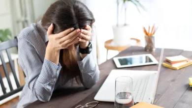 Tired woman with mental fatigue at work