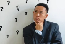 Man overthinking conversations with question marks around him