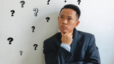 Man overthinking conversations with question marks around him